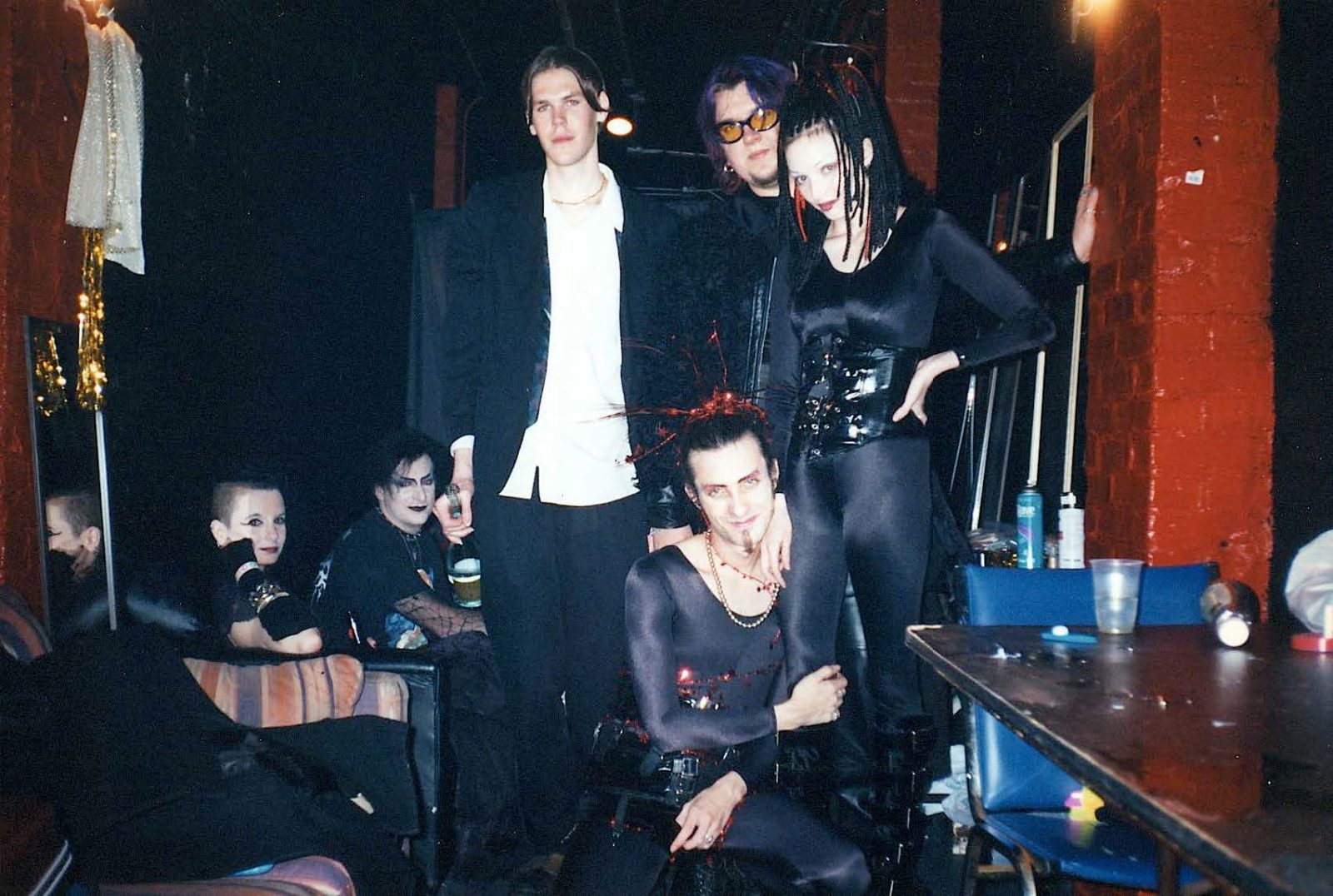 Goth band backstage posing in dark club