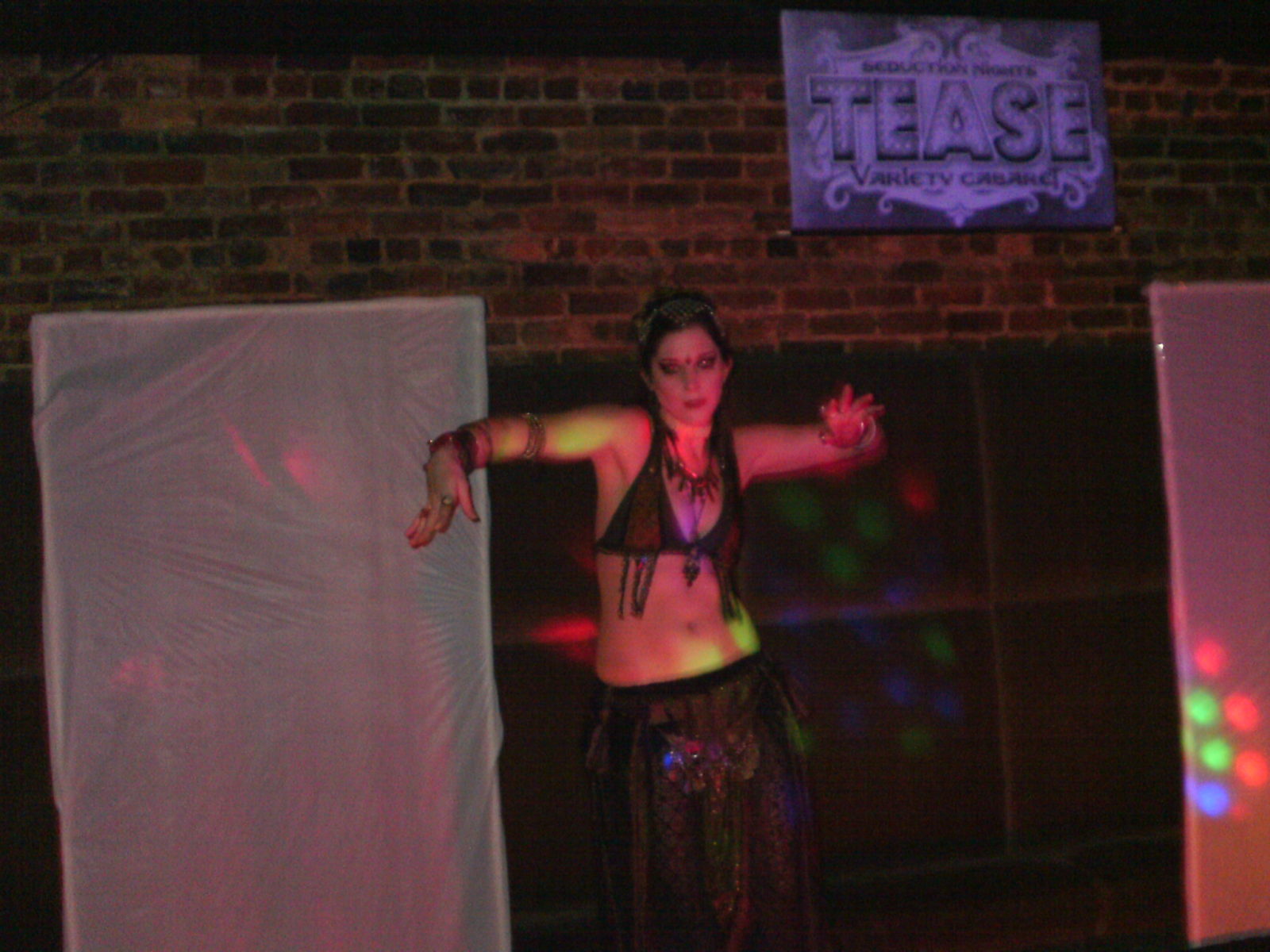 Belly dancer performing on dimly lit stage